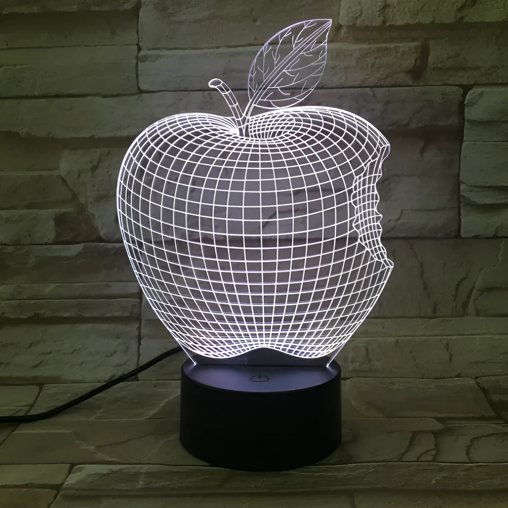 3D fruit-shaped colourful night light with acrylic shade and touch control on a dark surface