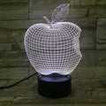 3D fruit-shaped colourful night light with acrylic shade and touch control on a dark surface