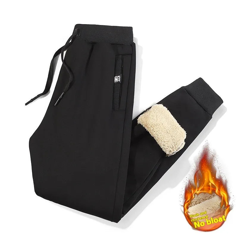 Men's grey fleece-lined cotton oversized track pants on a hanger, showing mid waist and straight leg.