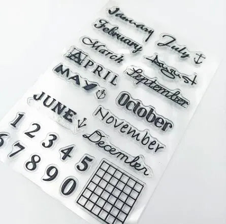 Close-up of a transparent silicone craft stamp featuring vintage-style calendar icons on a digital table background.