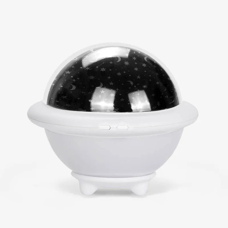 Pink UFO-shaped LED night light projecting a starry sky pattern on a wall.