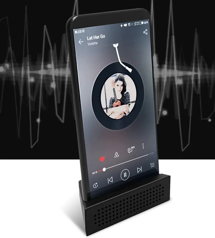 Portable black ABS mobile phone amplifier bracket holding an iPhone on a desk.