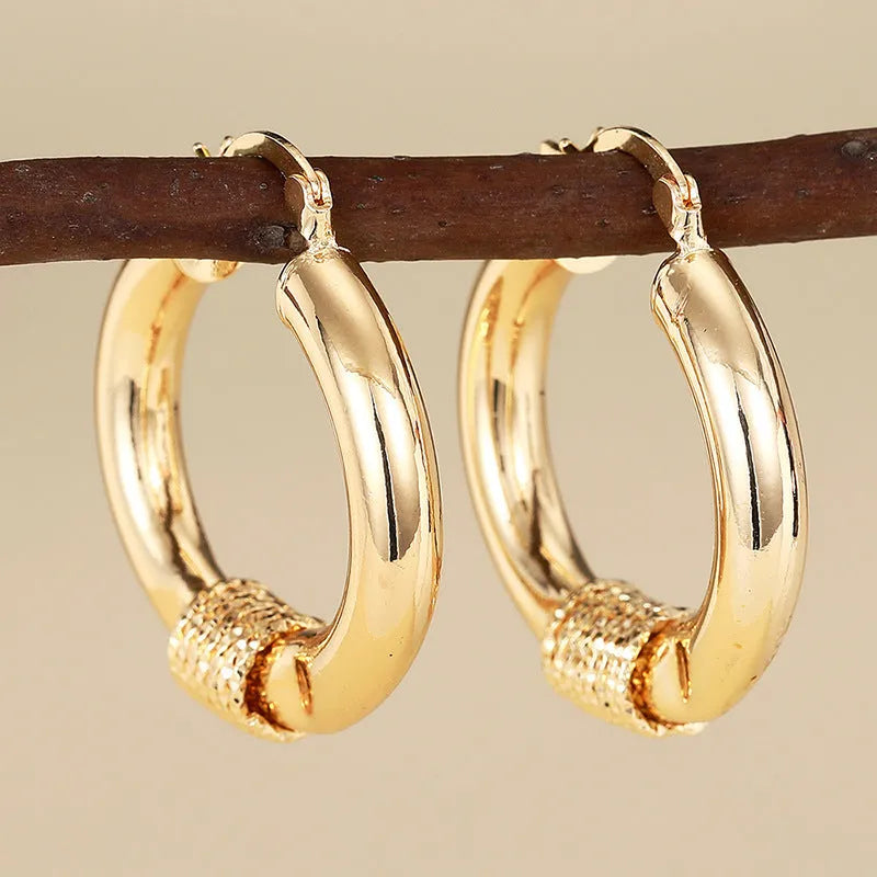 Geometric copper clip-on earrings with ring and line design elements