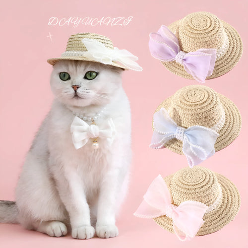 Woven straw hat for a cat with a large central pearl bow, available in blue, pink, purple, and white.