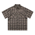Men's black and brown plaid short sleeve shirt with embroidered letter and lapel collar.