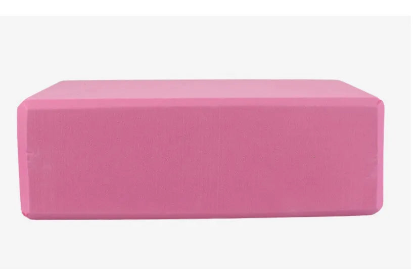 Pure colour EVA yoga brick, thick non-slip mat, and cotton tension band on a floor, in blue, purple, pink, red, black, gray