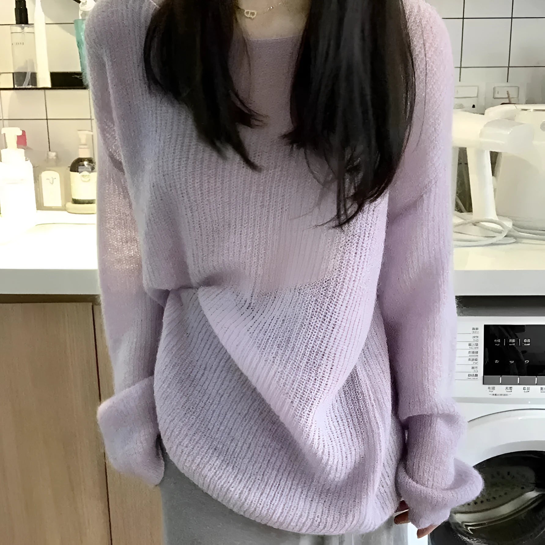 Purple women's sleeveless blouse with round neck and hollow out detailing on mannequin.