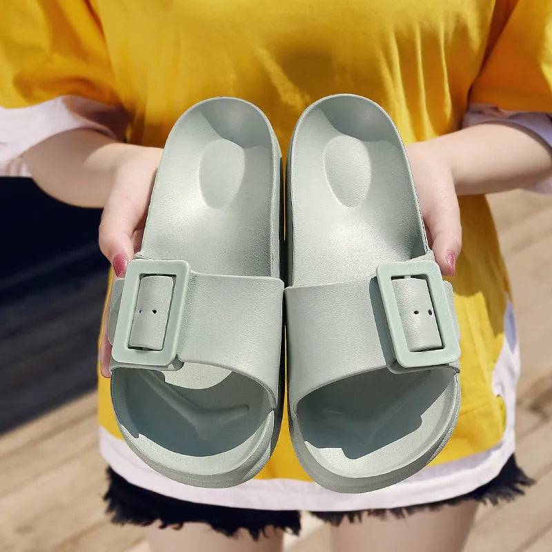 Women's grey blue EVA buckle slippers showing buckle detail and textured sole