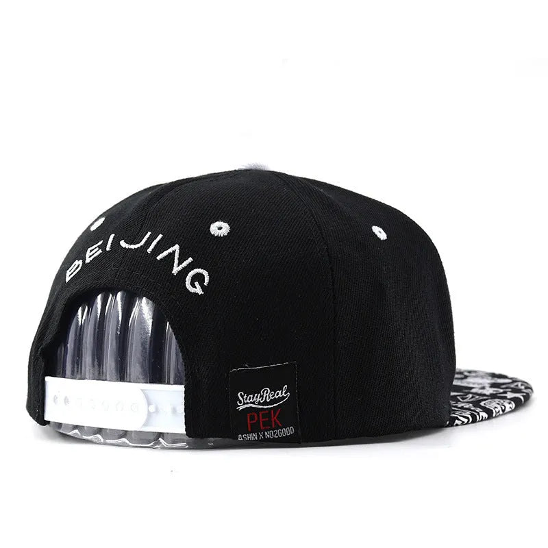 Cotton baseball cap with embroidered letters showing dome crown and adjustable back strap