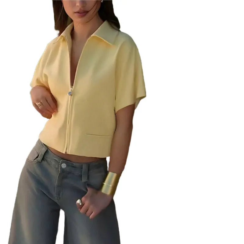 Woman's loose-fit short-sleeve casual top in black polyester fabric on a hanger.