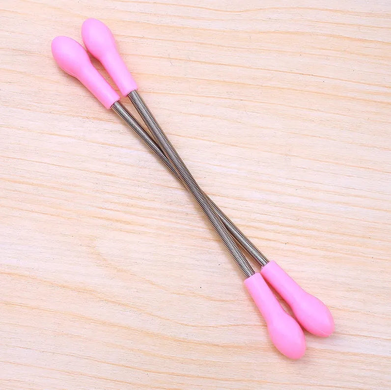 Pink facial hair remover with stainless steel spring and plastic handles, 19cm long, on a light background