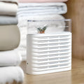 White reusable electric dehumidifier box with transparent top showing colour-changing silica gel crystals.