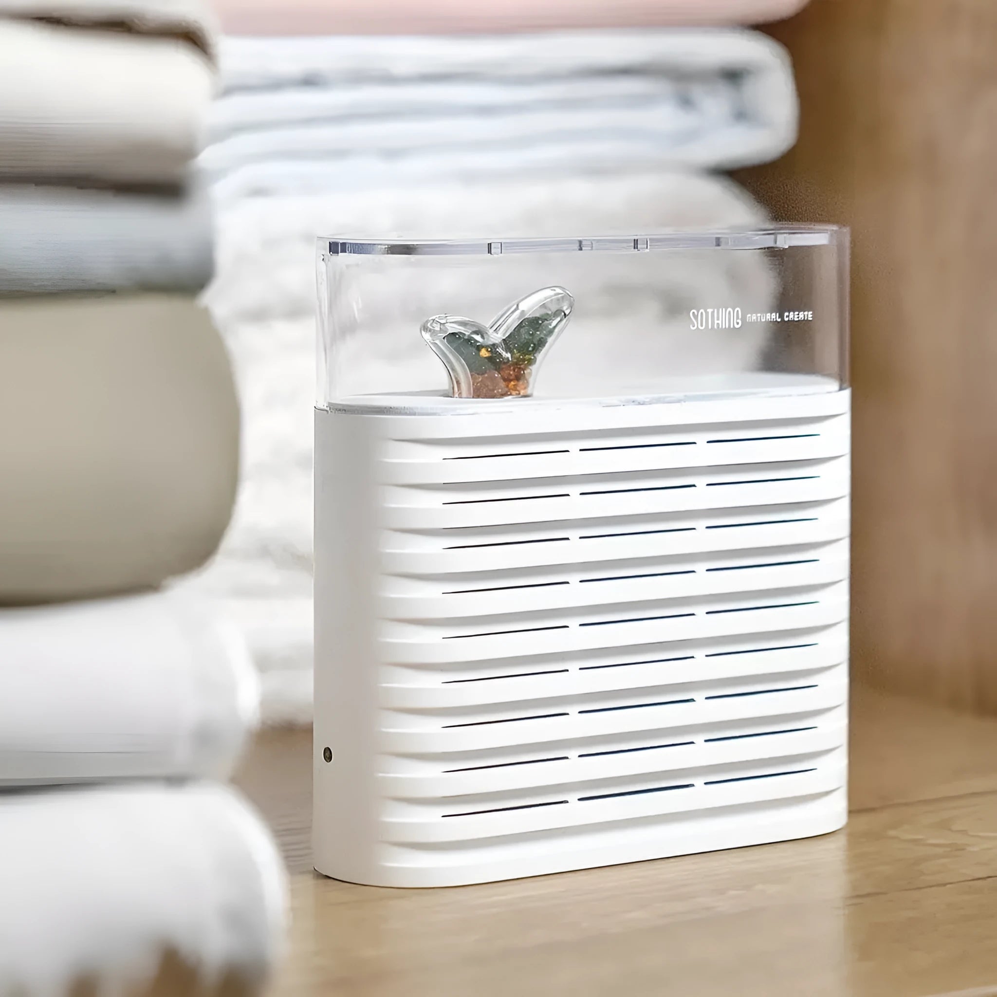 White reusable electric dehumidifier box with transparent top showing colour-changing silica gel crystals.