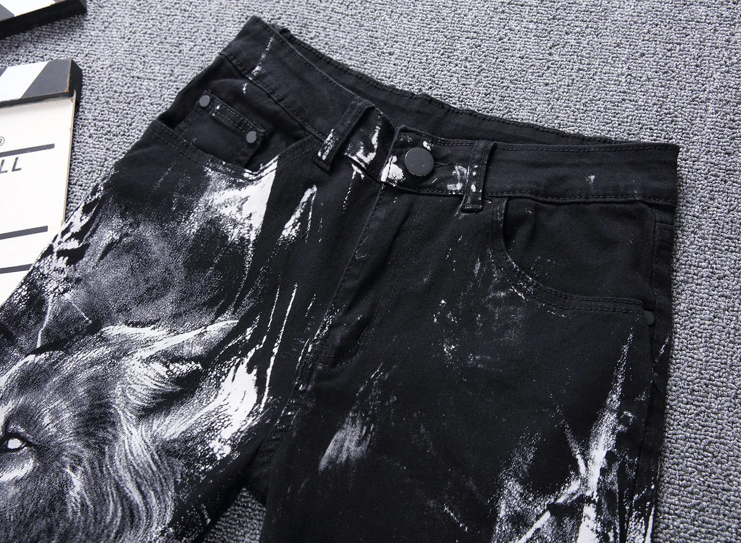 Men's black wolf print jeans with realistic wolf head design on cotton denim fabric