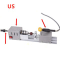Compact metal mini woodworking lathe with carving knives on workbench