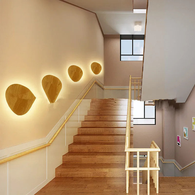 Log Art wood LED wall lamp with oval shape and warm light on a white wall