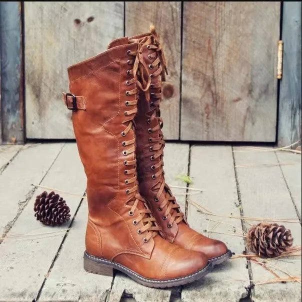 Women's black casual high leg boots with a chunky low heel and round toe on a plain background
