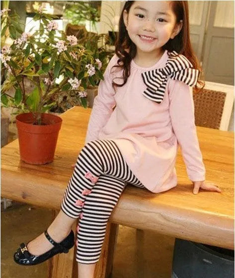 Pink cotton jersey knit clothing set for a girl, showing short-sleeved top and elasticated waist trousers.