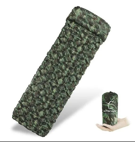 Blue camouflage inflatable camping sleeping pad made of diamond-pattern nylon on outdoor ground