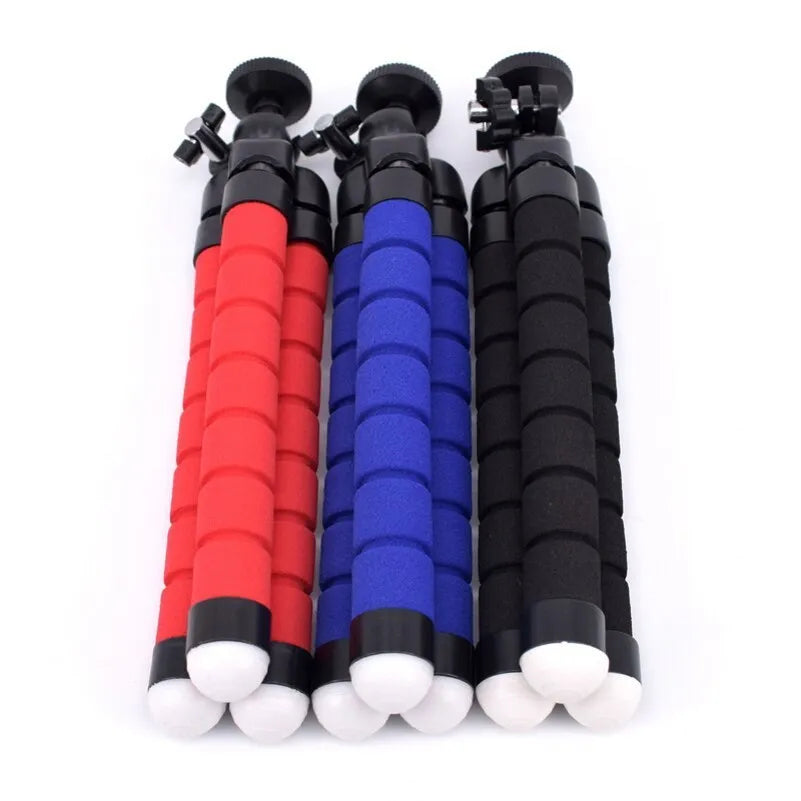 Black flexible octopus tripod with wrapped legs next to a smartphone, showing its 18cm size and universal screw mount.