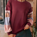 Women's loose plaid long-sleeved casual top in apricot colour on a hanger.