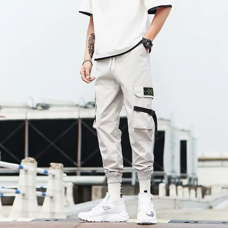 Hip hop jogger pants in khaki cotton fabric with elastic cuffs, shown flat
