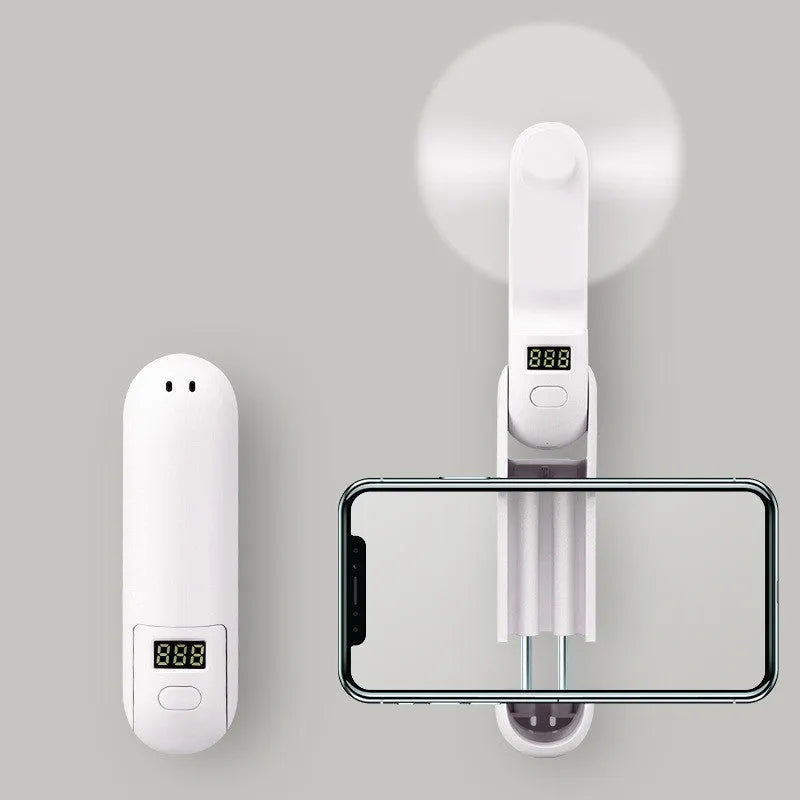 Green folding mini USB rechargeable personal desk fan with plastic blades.