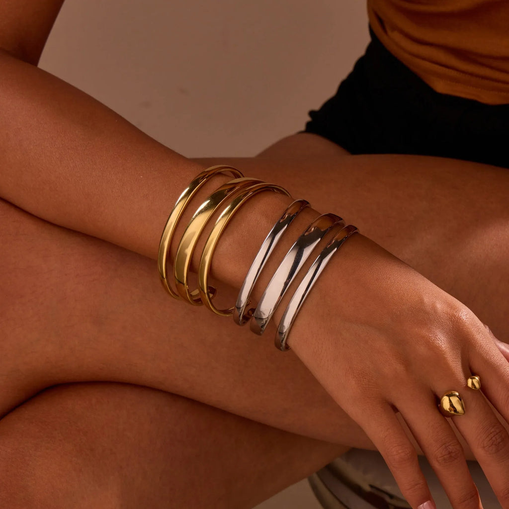 Gold and steel colour geometric line design stainless steel bracelet for women with simple opening clasp.
