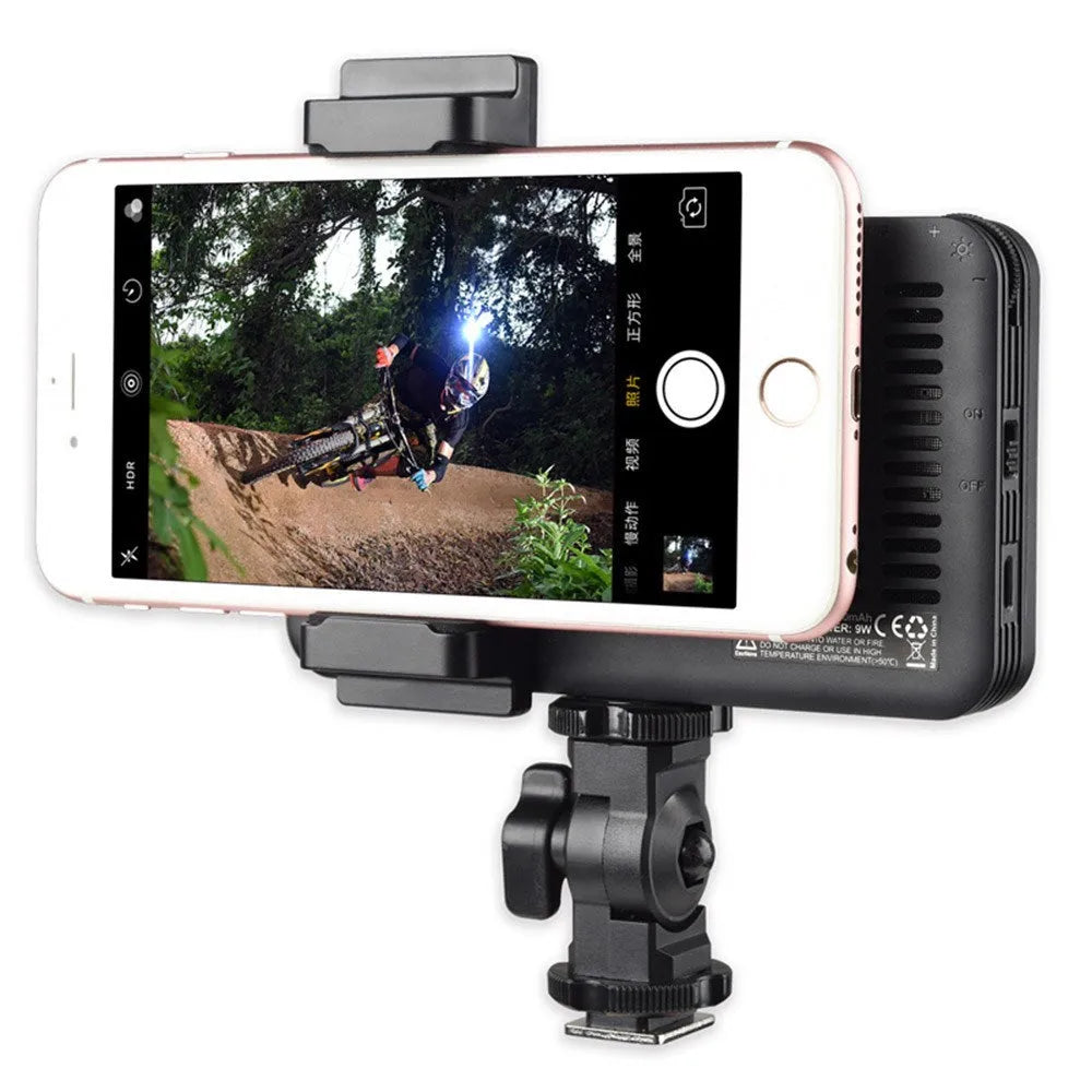 Slim silver Shenniu M150 LED video light mounted on a mobile phone showing its thin 20mm aluminium profile.