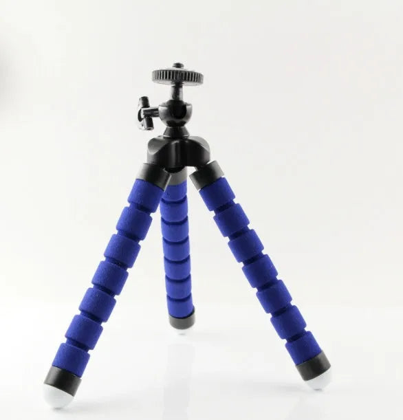 Black flexible octopus tripod with wrapped legs next to a smartphone, showing its 18cm size and universal screw mount.