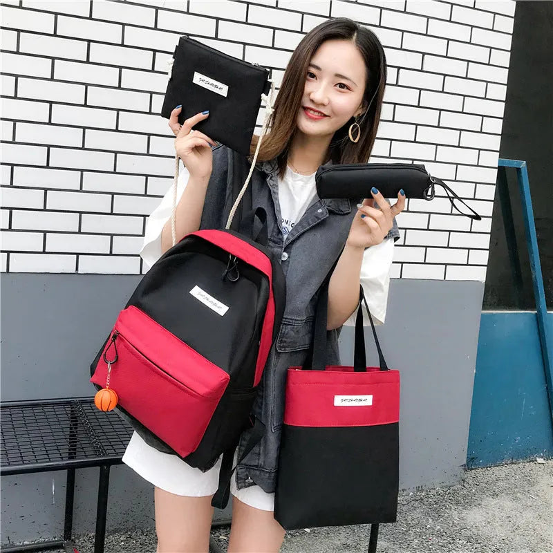 Four medium canvas backpacks in black, green, red, and white with zipper closure and air cushion straps