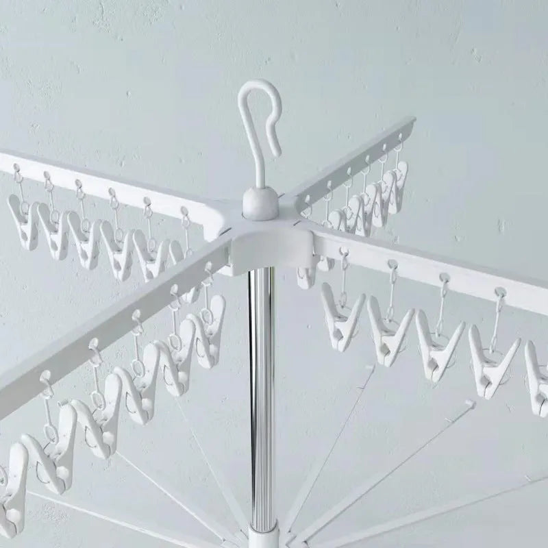 Stainless steel three-layer mobile drying rack with plastic clips and a clothes hanger.