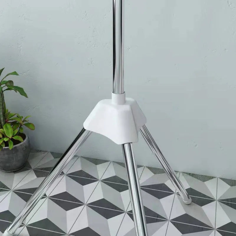 Stainless steel three-layer mobile drying rack with plastic clips and a clothes hanger.