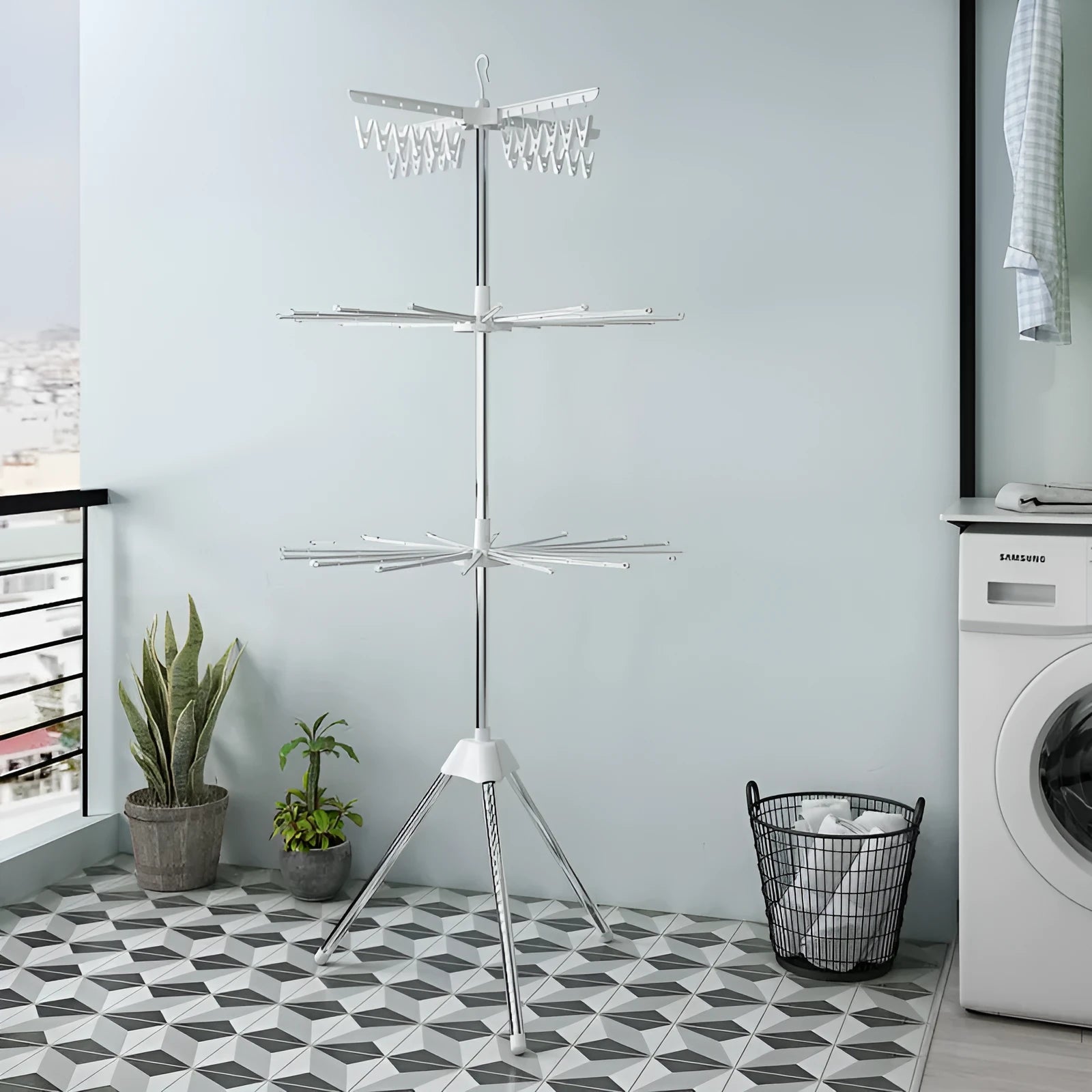 Stainless steel three-layer mobile drying rack with plastic clips and a clothes hanger.