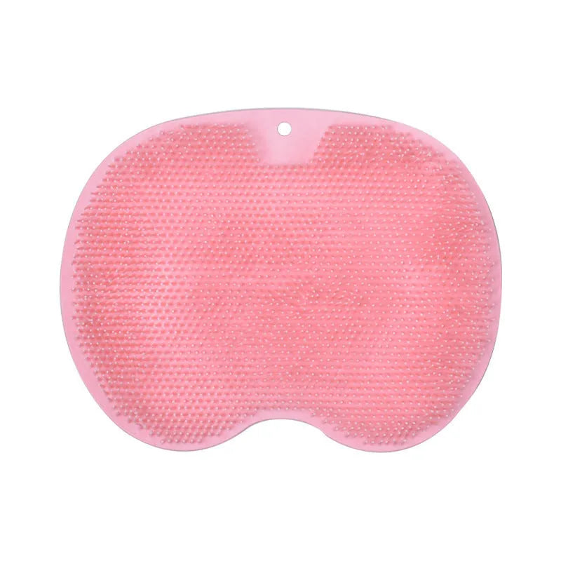 Orange TPR bath brush with silicone bristles and suction cups on base, shown on bathroom tiles.