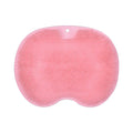 Orange TPR bath brush with silicone bristles and suction cups on base, shown on bathroom tiles.