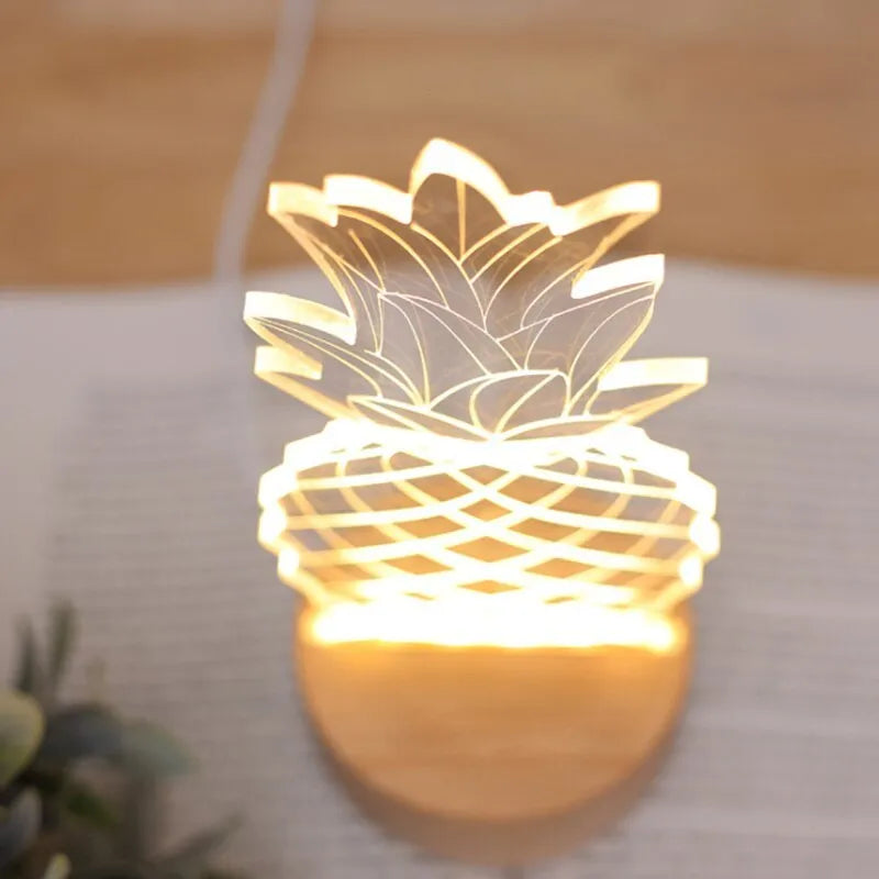 Wood and acrylic dimmable pineapple-shaped USB night light on a table.