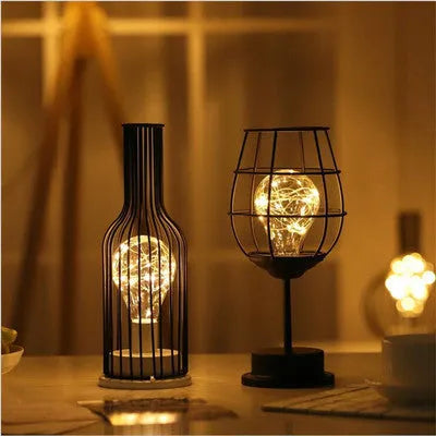 Minimalist hollow iron table lamp in wine glass or bottle design with warm white LED light