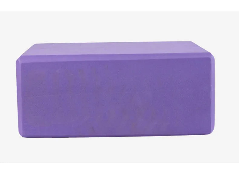 Pure colour EVA yoga brick, thick non-slip mat, and cotton tension band on a floor, in blue, purple, pink, red, black, gray