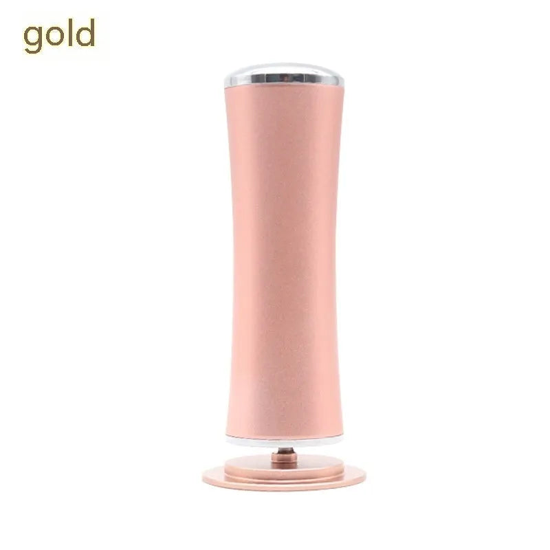 Electric foot callus remover with sandpaper disc attached for removing dead skin and calluses from heels