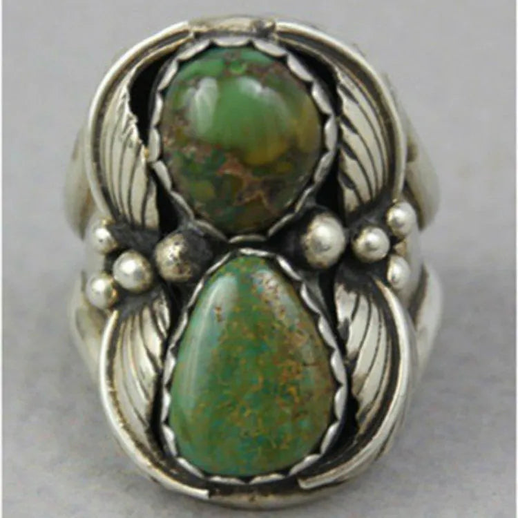 Geometric turquoise-coloured alloy ring for women on a grey background.