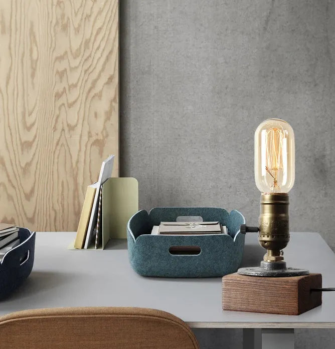 Compact water pipe design table lamp made from wood and iron on a wooden surface.