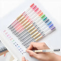 Set of 12 black Muji gel pens with 0.5mm nibs showing anti-leak ink mechanism detail