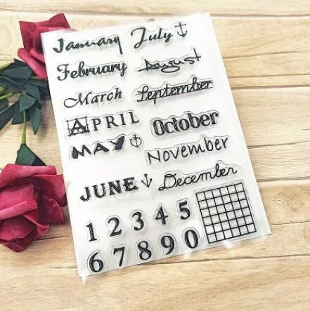 Close-up of a transparent silicone craft stamp featuring vintage-style calendar icons on a digital table background.
