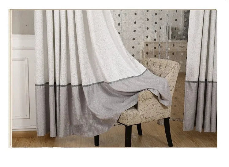 A single blackout curtain panel hung on a track, demonstrating its light-blocking fabric and hook-style header.