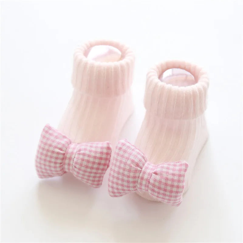 Cotton baby floor socks in various colours and patterns with size guide for ages 0-3 months