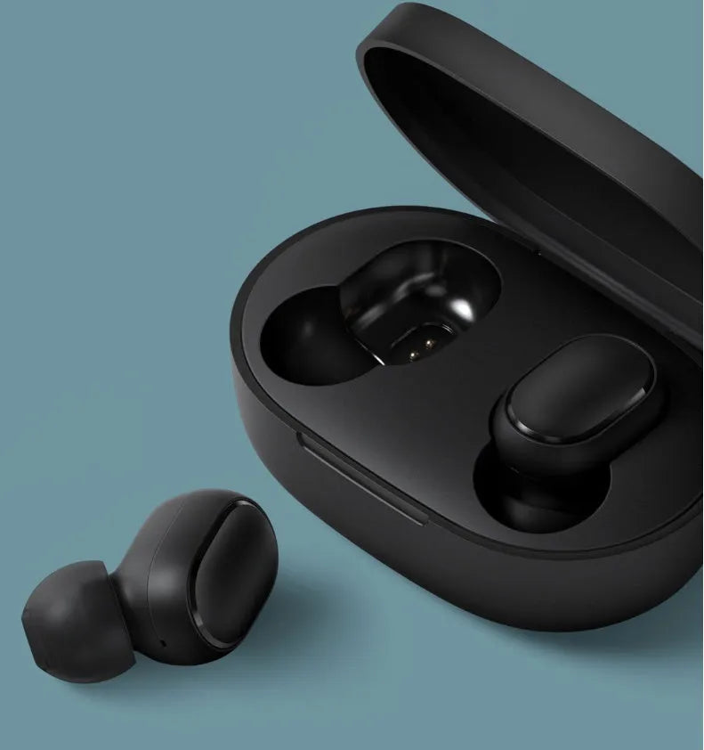 Redmi AirDots black true wireless earbuds next to their white charging case.