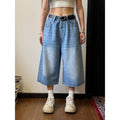 Men's loose straight-leg denim shorts in blue on a plain background