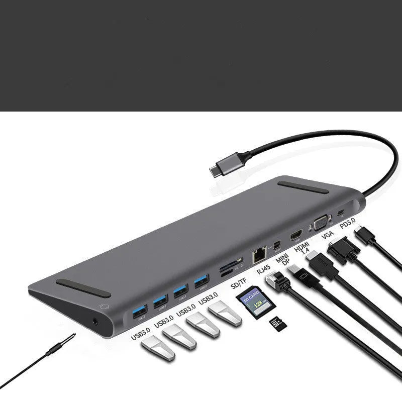 Grey aluminium alloy 12-in-1 Type-C hub with HDMI, VGA, USB 3.0, Ethernet, and PD ports on a desk