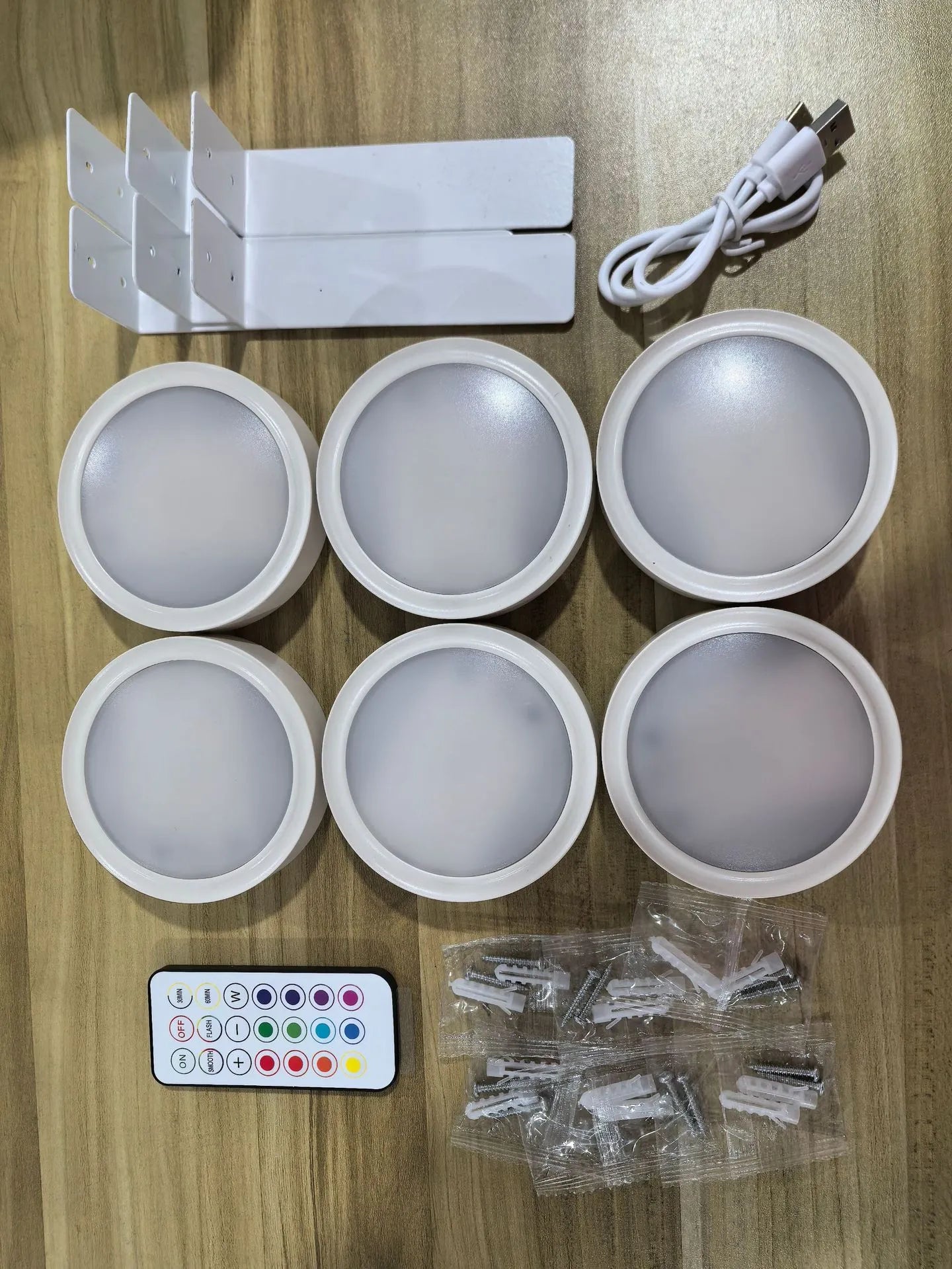 Wireless LED painting lamp with a magnetic mounting belt and remote control in black finish.